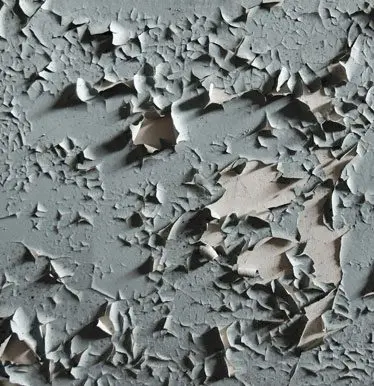 A close up of the surface of a gray concrete wall.