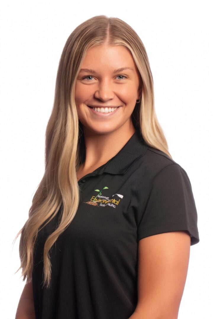 A woman in black shirt smiling for the camera.