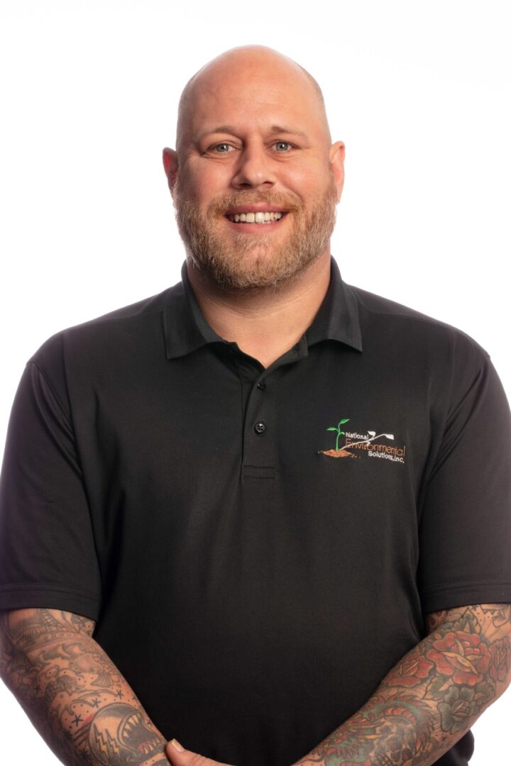 A man with tattoos wearing a black shirt.