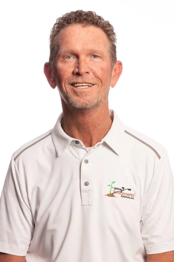 A man in white shirt smiling for the camera.